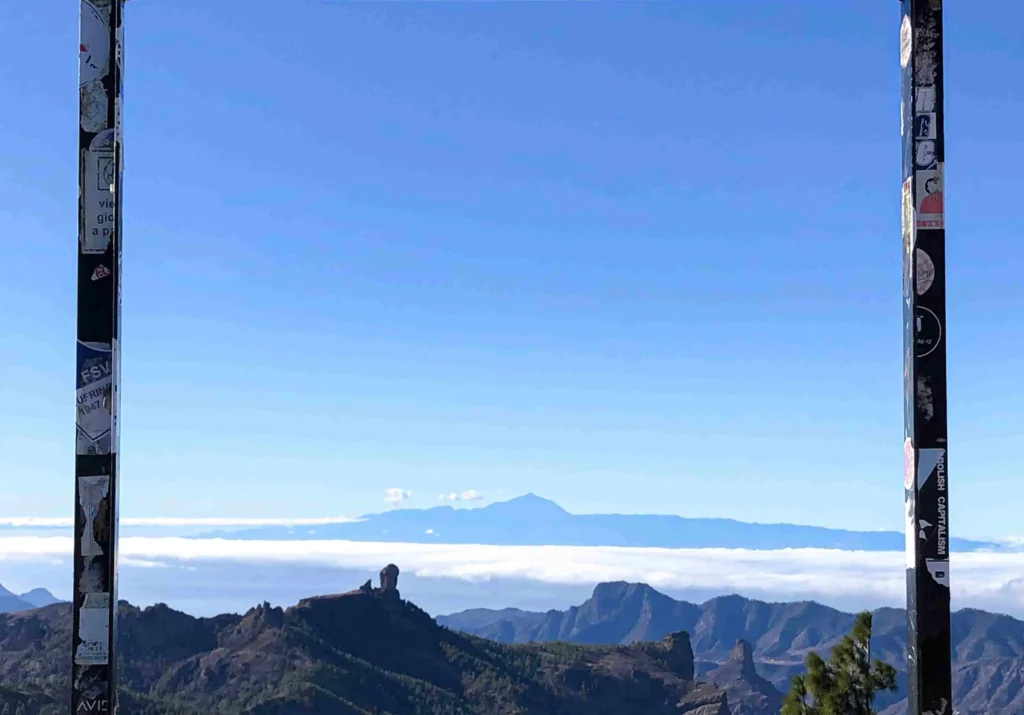 A viewpoint on the mountaintop of Gran Canaria island, located in Spain, where the entire panorama can be appreciated, some strips of white paper are placed on a rectangular metal arch that was already in place, simulating the frame of social media posts, with the legend: The screen that matters.