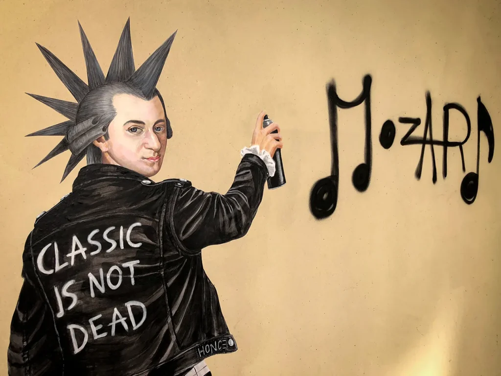 Painting of Mozart with a punk hairstyle in a leather jacket reading 'Classics is not dead', painting a musical note graffiti
