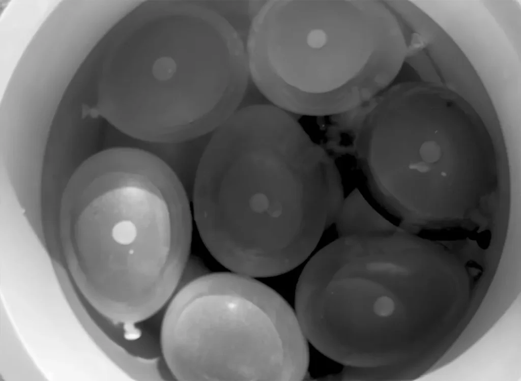 Bucket filled with colorful water balloons